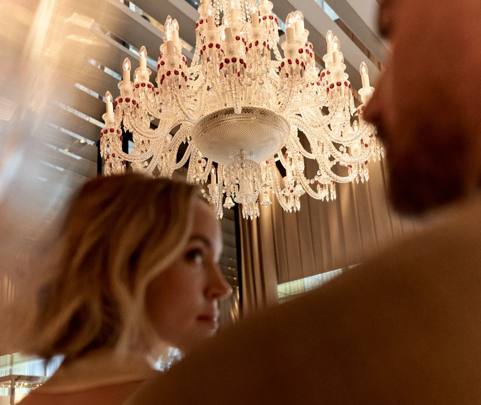 Baccarat Maison experience: guests beneath a crystal chandelier